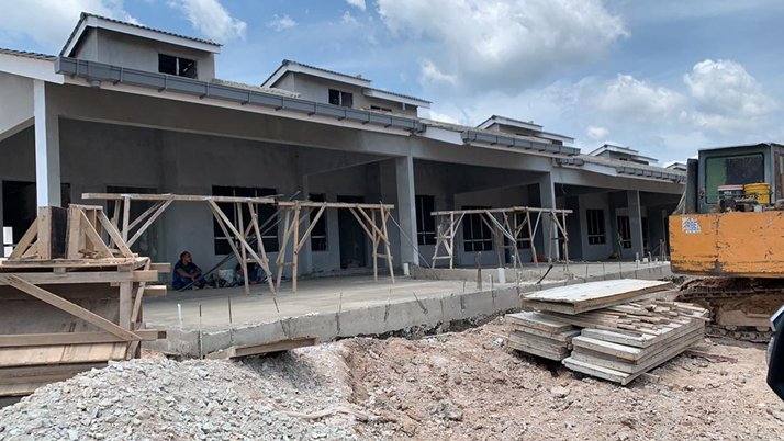 Row of terrace houses under construction with timber formwork, OSK Seremban